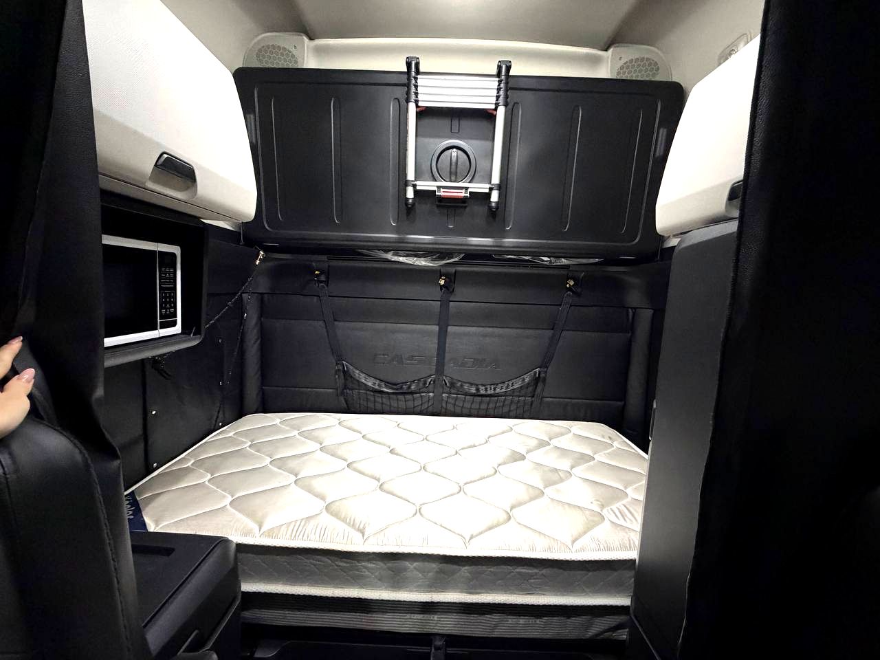 Sleeper berth with a brand-new mattress still in its wrap