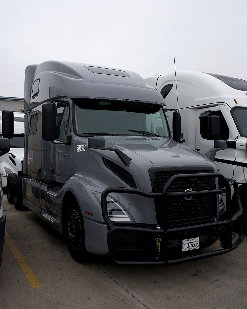 Grey Volvo VNL tractor with a grille guard in the Rogue Carrier fleet